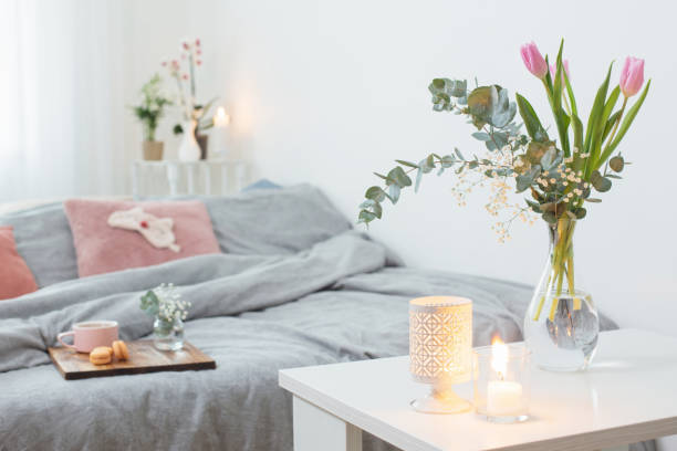 interior of bedroom with flowers, candles and cup of tea - tulip vase flower spring imagens e fotografias de stock