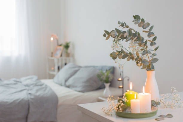 istock burning candles and eucalyptus in  vase in white bedroom 1199718673