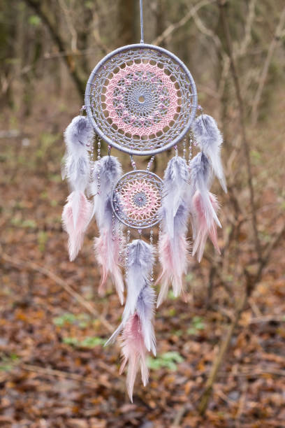 istock Handmade dream catcher with feathers threads and beads rope hanging 1199719281
