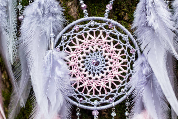 istock Handmade dream catcher with feathers threads and beads rope hanging 1199719283