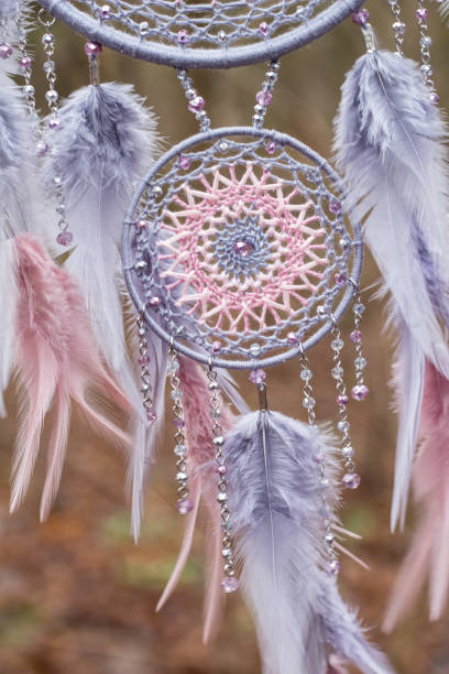 istock Handmade dream catcher with feathers threads and beads rope hanging 1199719296