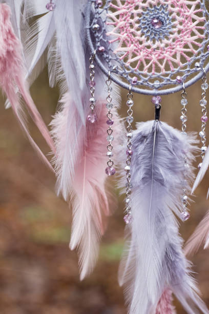 istock Handmade dream catcher with feathers threads and beads rope hanging 1199719301