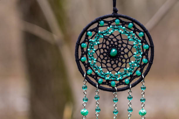 istock Handmade dream catcher with feathers threads and beads rope hanging 1199719303