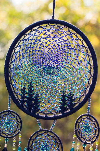 istock Handmade dream catcher with feathers threads and beads rope hanging 1199719338