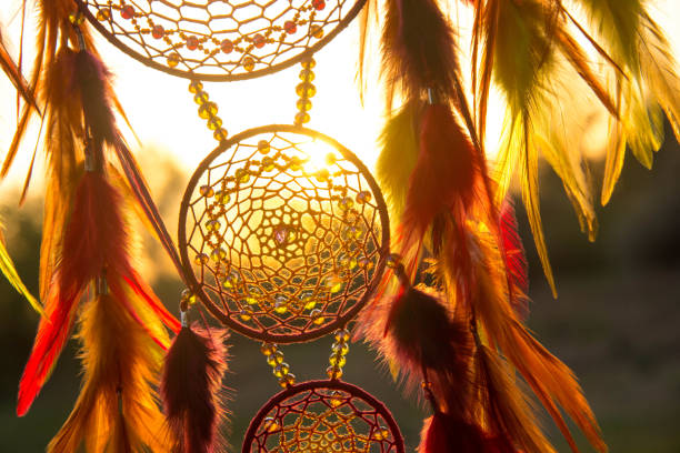 istock Handmade dream catcher with feathers threads and beads rope hanging 1199719342