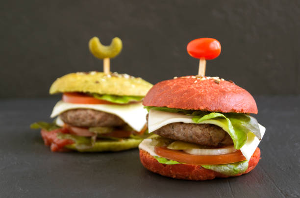 istock burgers with colored buns on a black background. 1199719456