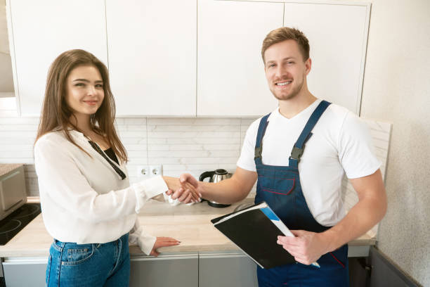 istock young smiling man plumber and brunette woman client shaking hands after successful work on water tap installation both looking satisfied professional repair service 1199720343