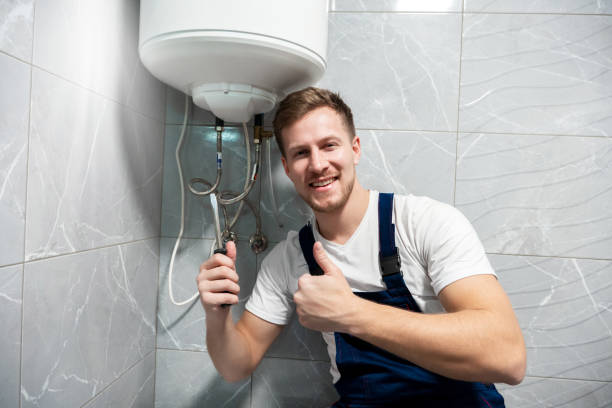 istock smiling man worker in uniform with screwdriver in one hand and showing like with another hand repairing boiler at home in toilette professional repair service 1199720390