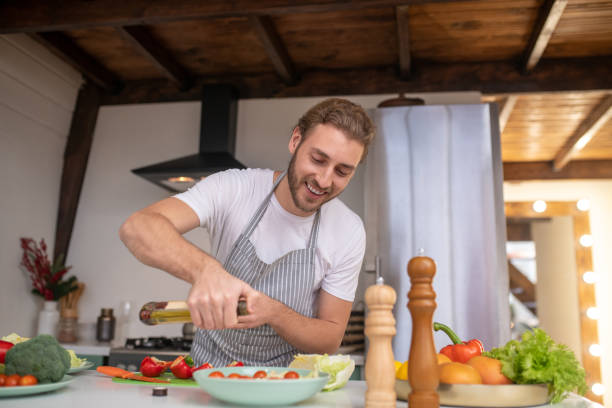 istock Concentrated amn putting oil into a dish 1199720685