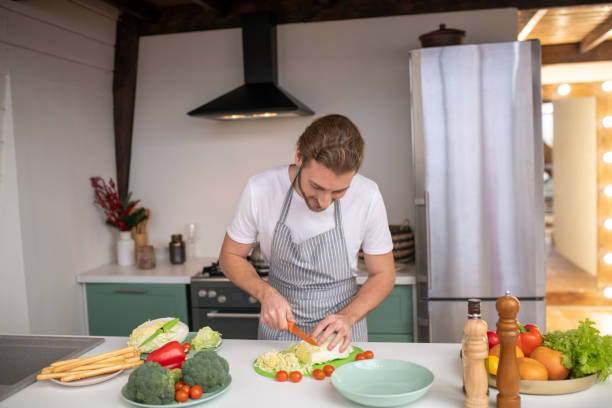 istock Man cutting cabbage for a tasty salad 1199720813