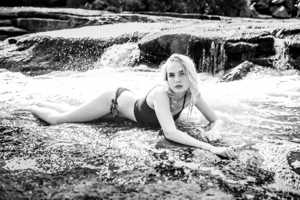 istock Young blonde in water at a waterfall 1199722055