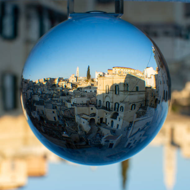 istock The Sassi di Matera enclosed in a Cristal Sphere on Blue Sky Background 1199722343