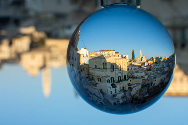 istock The Sassi di Matera enclosed in a Cristal Sphere on Blue Sky Background 1199722495