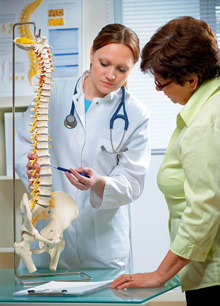 chiropratica - human spine chiropractic adjustment back pain foto e immagini stock