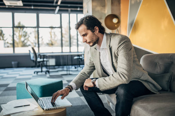 istock Businessman working on laptop in the modern office 1199726775