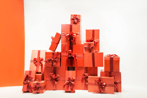 istock A lot of beautiful gift boxes on white and red background 1199728425