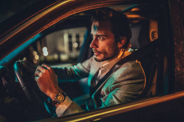 istock Businessman Driving A Car In Night 1199728799