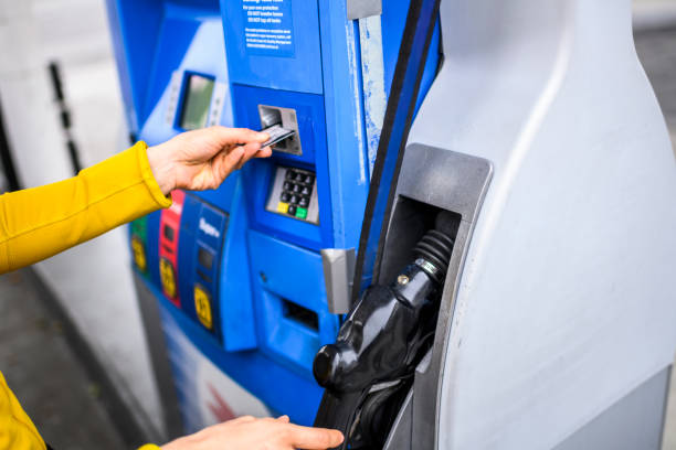 Paying for fuel using a credit card at a gas station stock photo