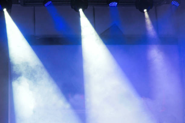 istock Spotlights and laser beams. Concert light. Stage lights 1199729755