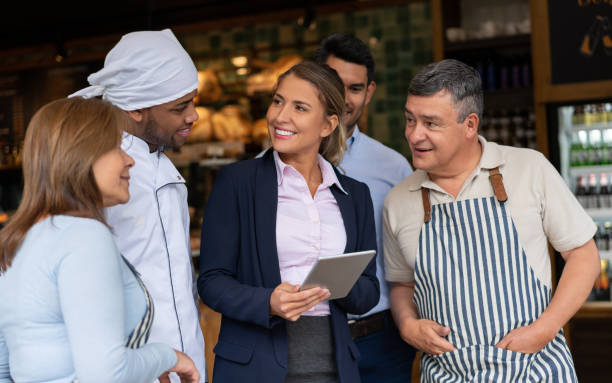 istock Business manager talking to her staff at a cafe 1199731104