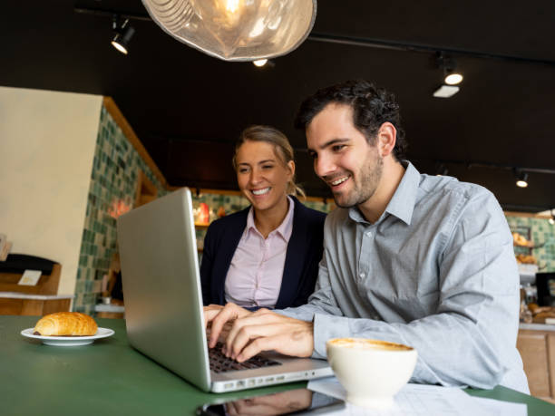 istock Happy business partners working online at a cafe 1199731358