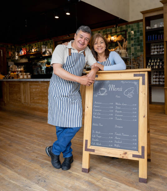 istock Business owners working at a cafe and displaying their menu 1199731370