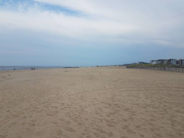 istock ocean water at coast or shore with sand and buildings 1199733864