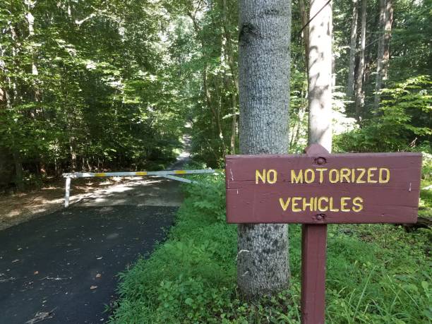 istock no motorized vehicles sign and asphalt trail and forest 1199733873