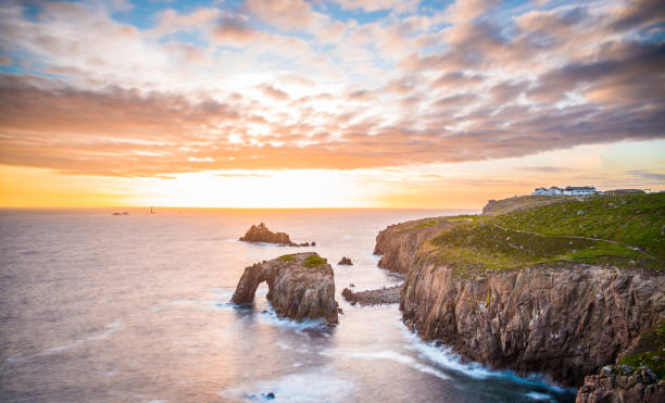 Dramatic sky at sunset with Enys Dodnan and the Armed Knight rock formations