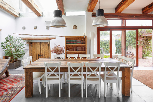 Bright dining area with big dining table and chairs in a Spanish modern farmhouse.