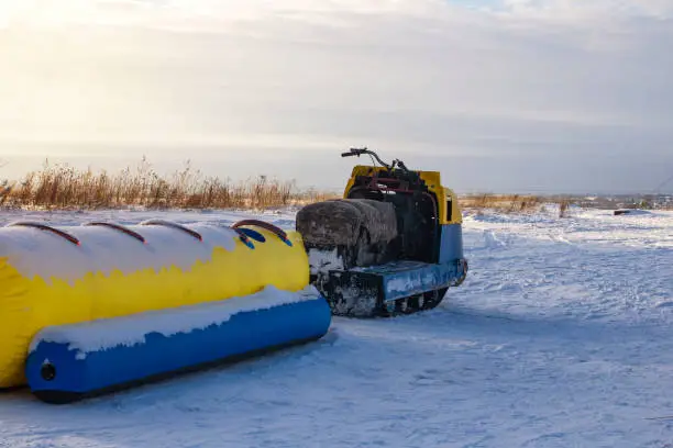 Photo of Riding an inflatable banana in the snow on a clear spring day.