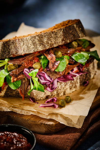 istock Juicy grilled beef sandwich with greens, capers and cabbage and sauce. 1199737894
