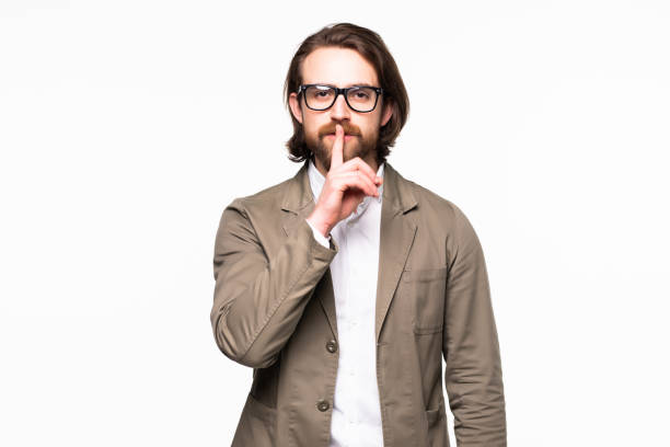 istock Business man with finger on lips asking for silence over white background 1199738638