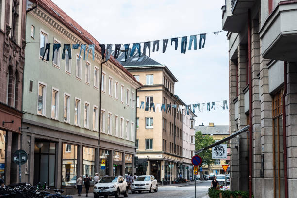 Malmo, Sweden - August 29, 2019: Trousers and clothes hanging in the middle of the street with people around in Malmö, Sweden