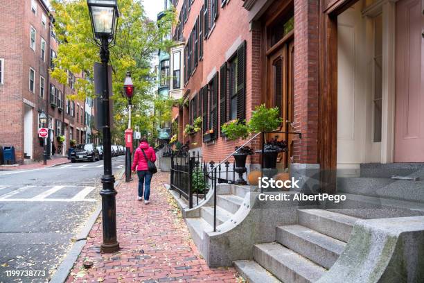 Woman Walking On The Sidewalk Of A Historic Residential District Stock Photo - Download Image Now