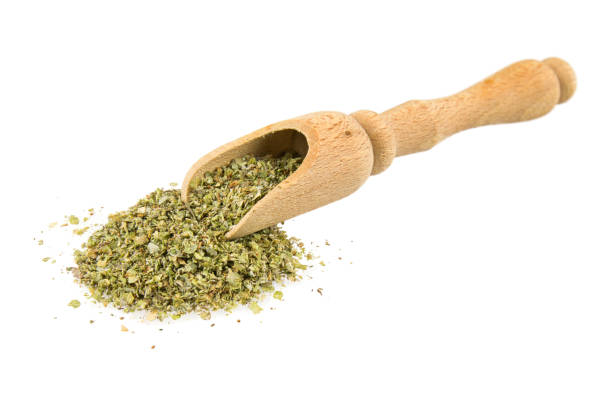 Pile of dried marjoram leaves Pile of dried marjoram leaves with wooden scoop isolated on white background in synch stock pictures, royalty-free photos & images
