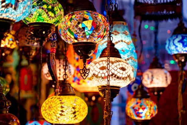istock Many beautiful lights made from mosaic patterns puzzled from multicolored glass pieces. Outdoors, night time, colorful lights on oriental street market. 1199740748