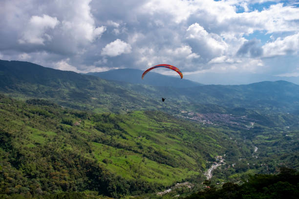 istock araglider flying over green mountains 1199743496