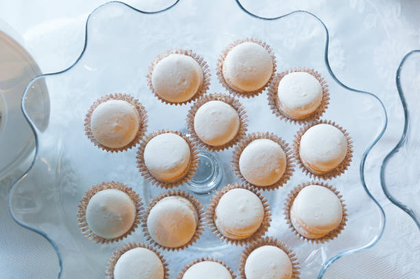 istock Tasty white mini cakes on a glass curved plate. Top view. 1199743918