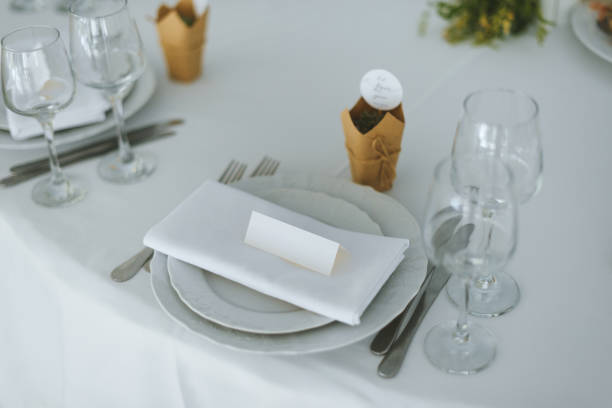 istock Wedding table with plate and white blank paper 1199744735