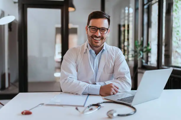 Portrait of a cheerful doctor in modern office.