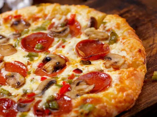 Photo of Deluxe Pepperoni Pizza with Mushrooms, Sausage and Peppers