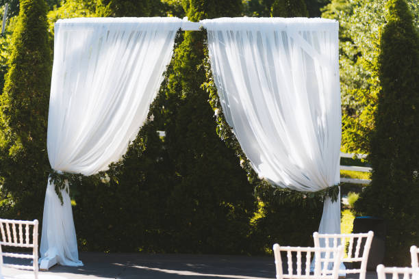 istock Wedding white simple arch for ceremony in sunny day 1199746266