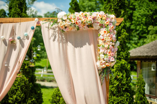 istock Wedding arch decoration with flowers in a sunny day 1199746399