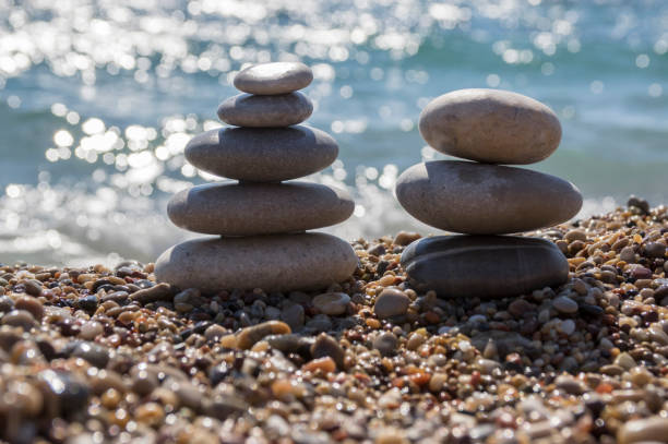 istock Stones and pebbles stack, harmony and balance, two stone cairns on seacoast 1199747273