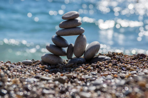 istock Stones and pebbles stack, harmony and balance, One big pyramid stone cairn on seacoast 1199747275
