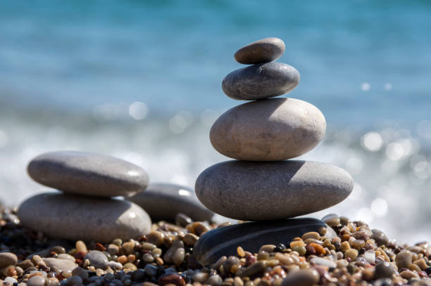 istock Stones and pebbles stack, harmony and balance, two stone cairns on seacoast 1199747310