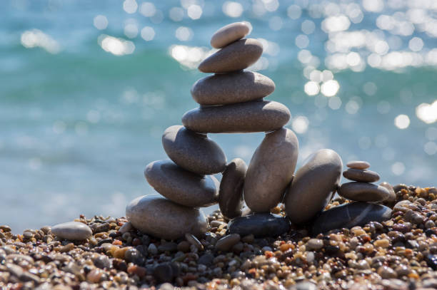 istock Stones and pebbles stack, harmony and balance, One big pyramid stone cairn on seacoast 1199747313