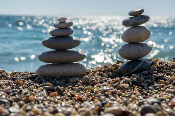 istock Stones and pebbles stack, harmony and balance, two stone cairns on seacoast 1199747347