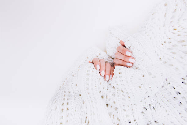 istock Stylish trendy white manicure. Tender female hands. 1199747627